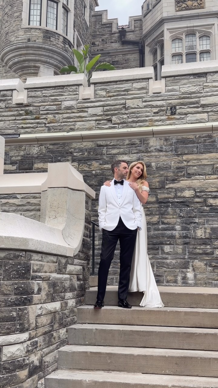 A newly married couple celebrating outside Casa Loma in Toronto
